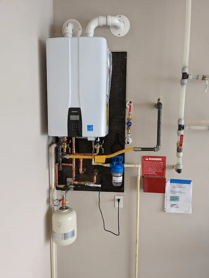 Professional plumber installing copper piping in a Westford home